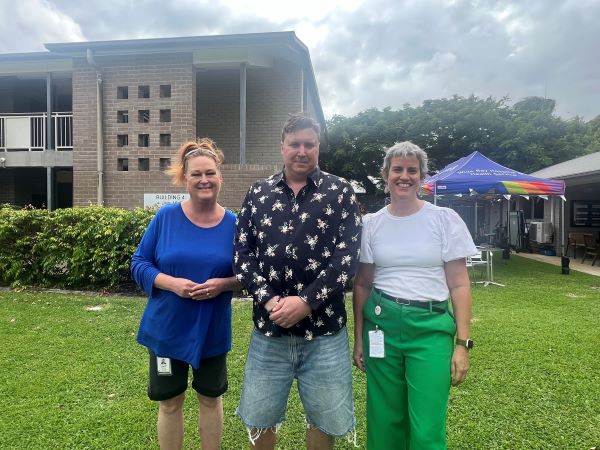 Three people celebrating the 10th birthday of the Community Care Unit.